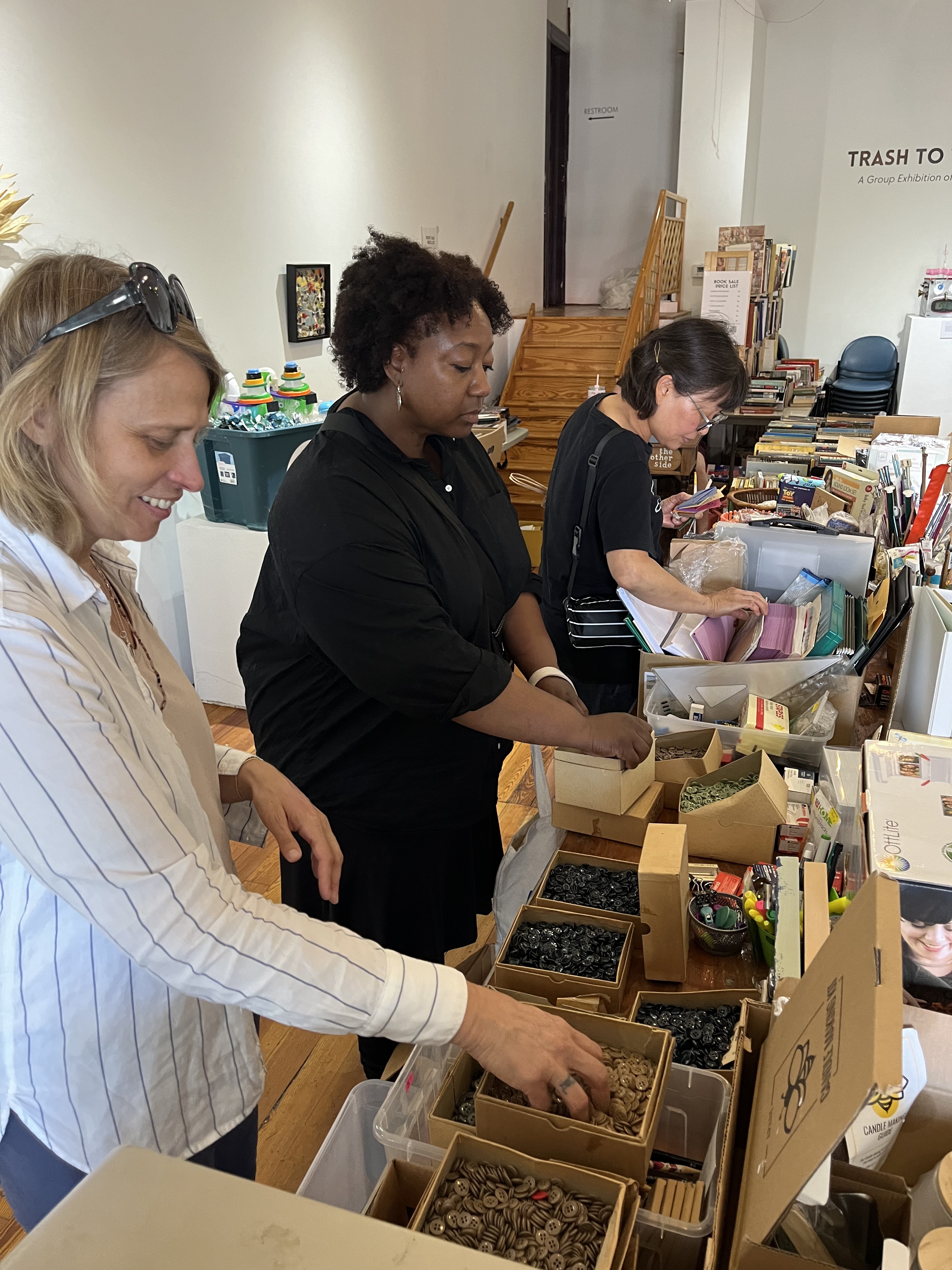 Artists peruse the buttons at our pop up shop at The Other Side in July 2024.