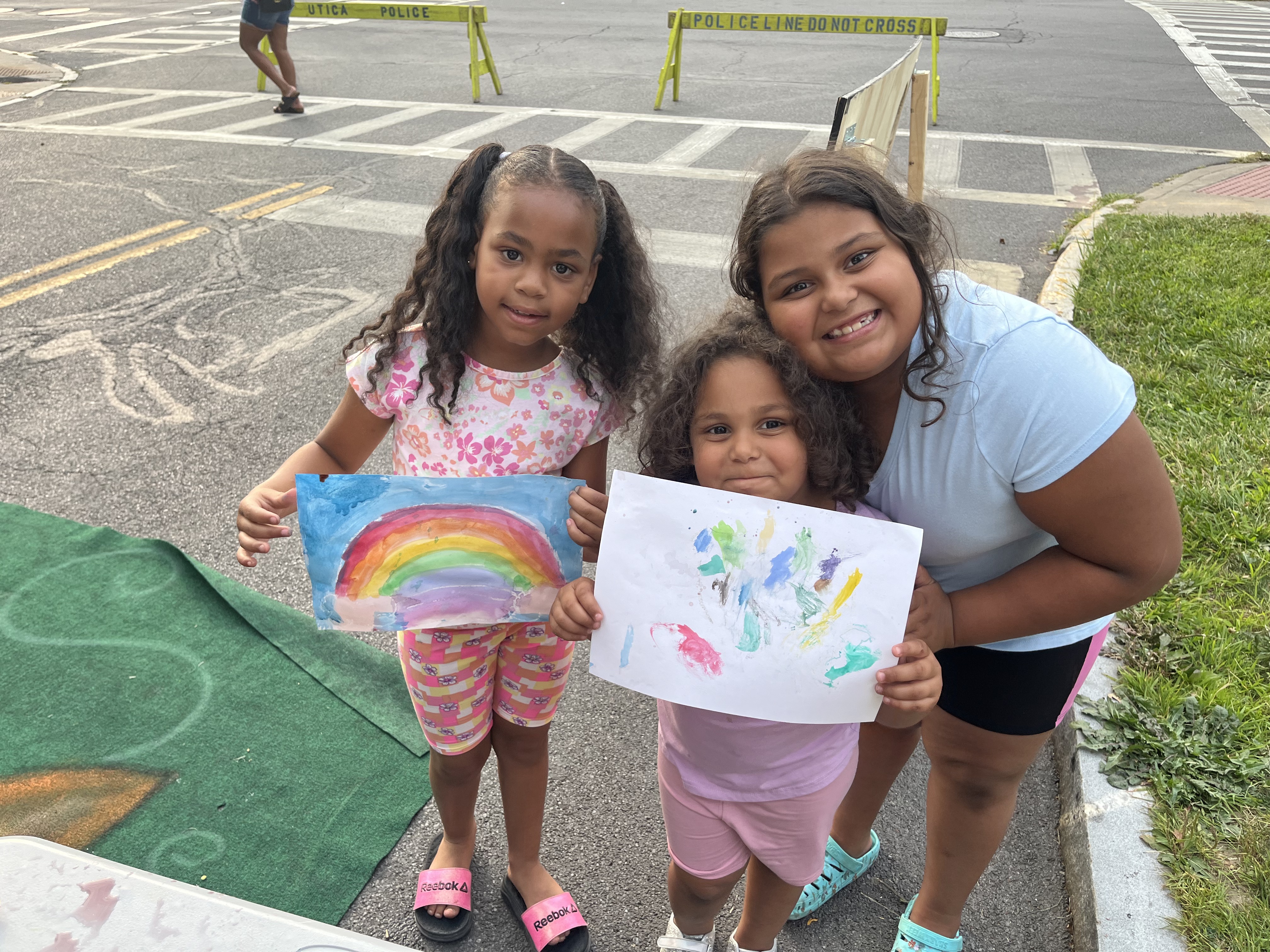 Three girls at Levitt Amp show off their watercolor work